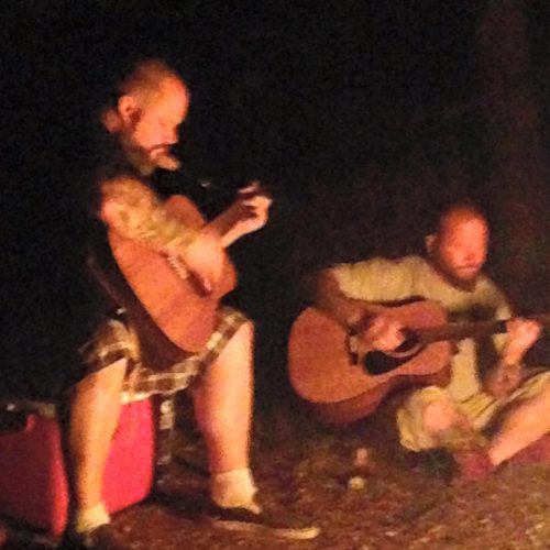 Brothers KIME perform acoustically by a campfire, with Ran Kime and Wes Kime blending raw vocals, guitar, and late-night storytelling.