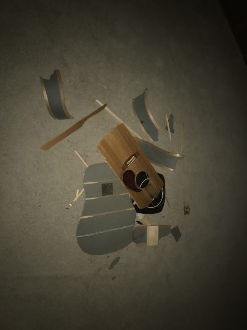A raw moment as Ran Kime smashes his Martin acoustic guitar, symbolizing frustration, release, and the intensity behind the music.