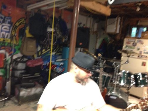 Ran Kime warming up on guitar during brothers KIME practice, highlighting the workmanlike routine behind live and studio performances.